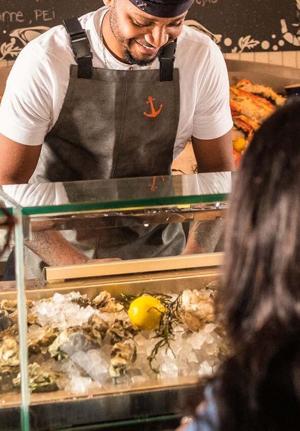a person shucking oysters