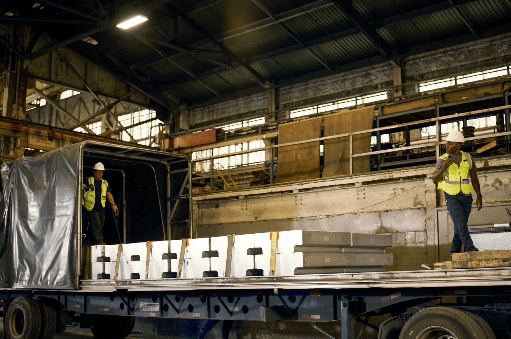 Two men in an industrial facility using RelayX to improve productivity