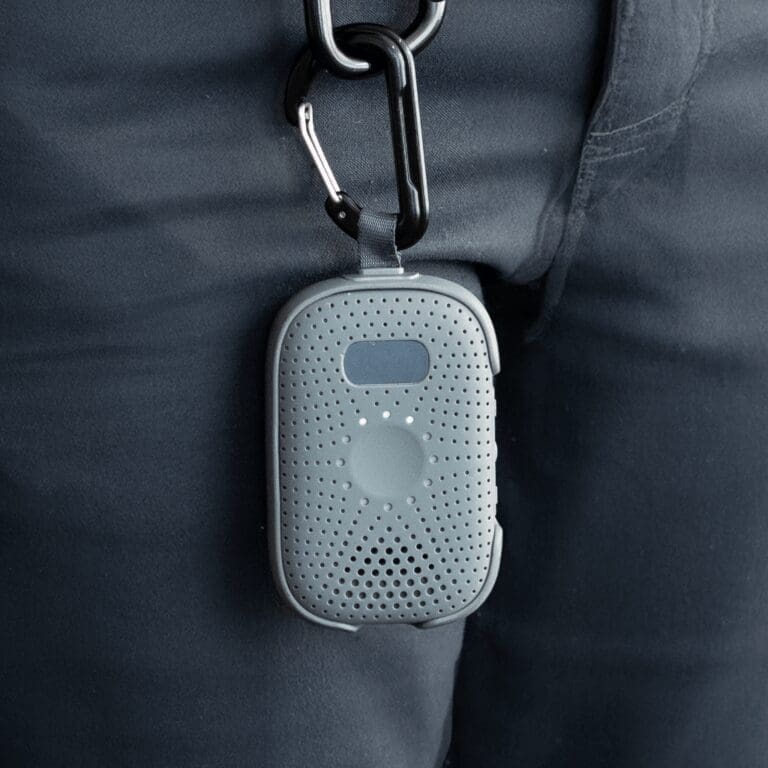 RelayM hanging from a carabiner clip on a user’s pants